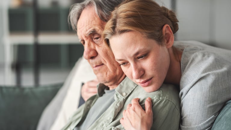 Daughter hugging her father sadly